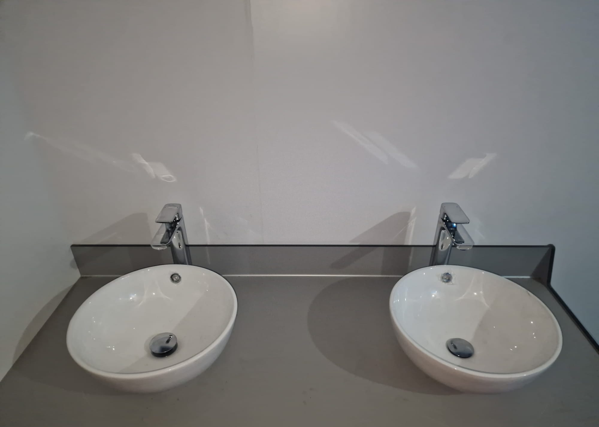Twin washbasins and taps in the welfare building