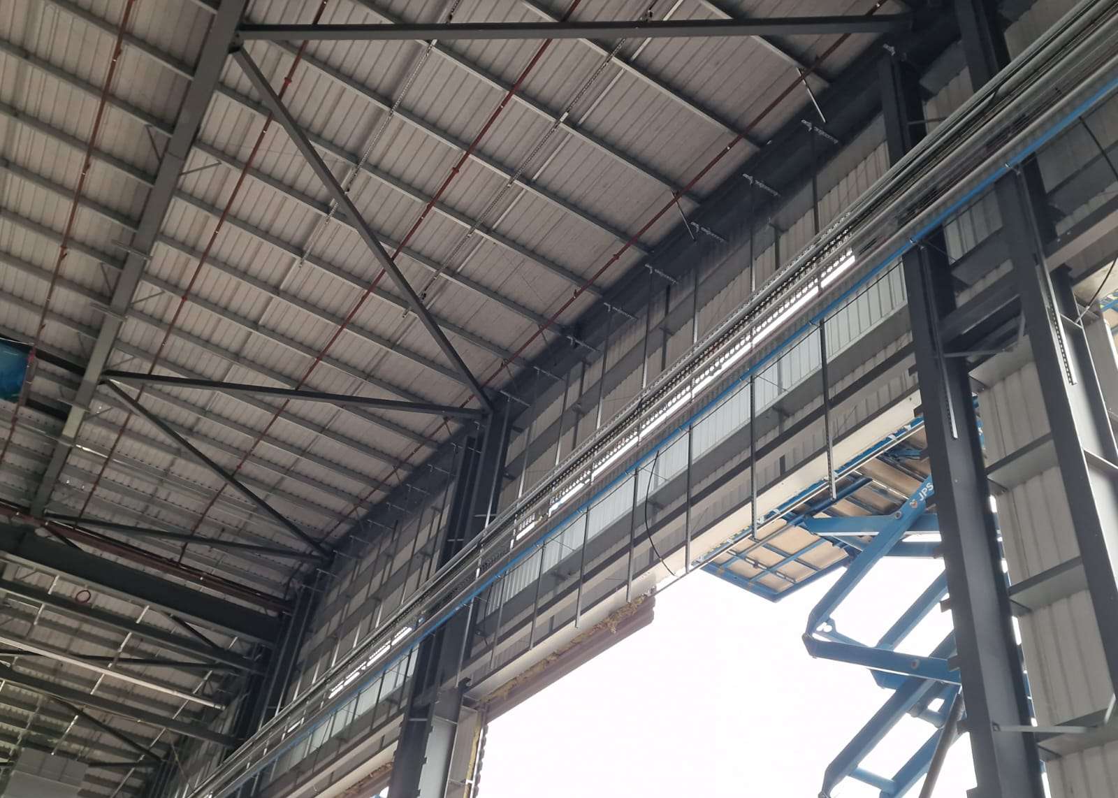 High-level blue MDPE pipework with scissor-lift access in the main building
