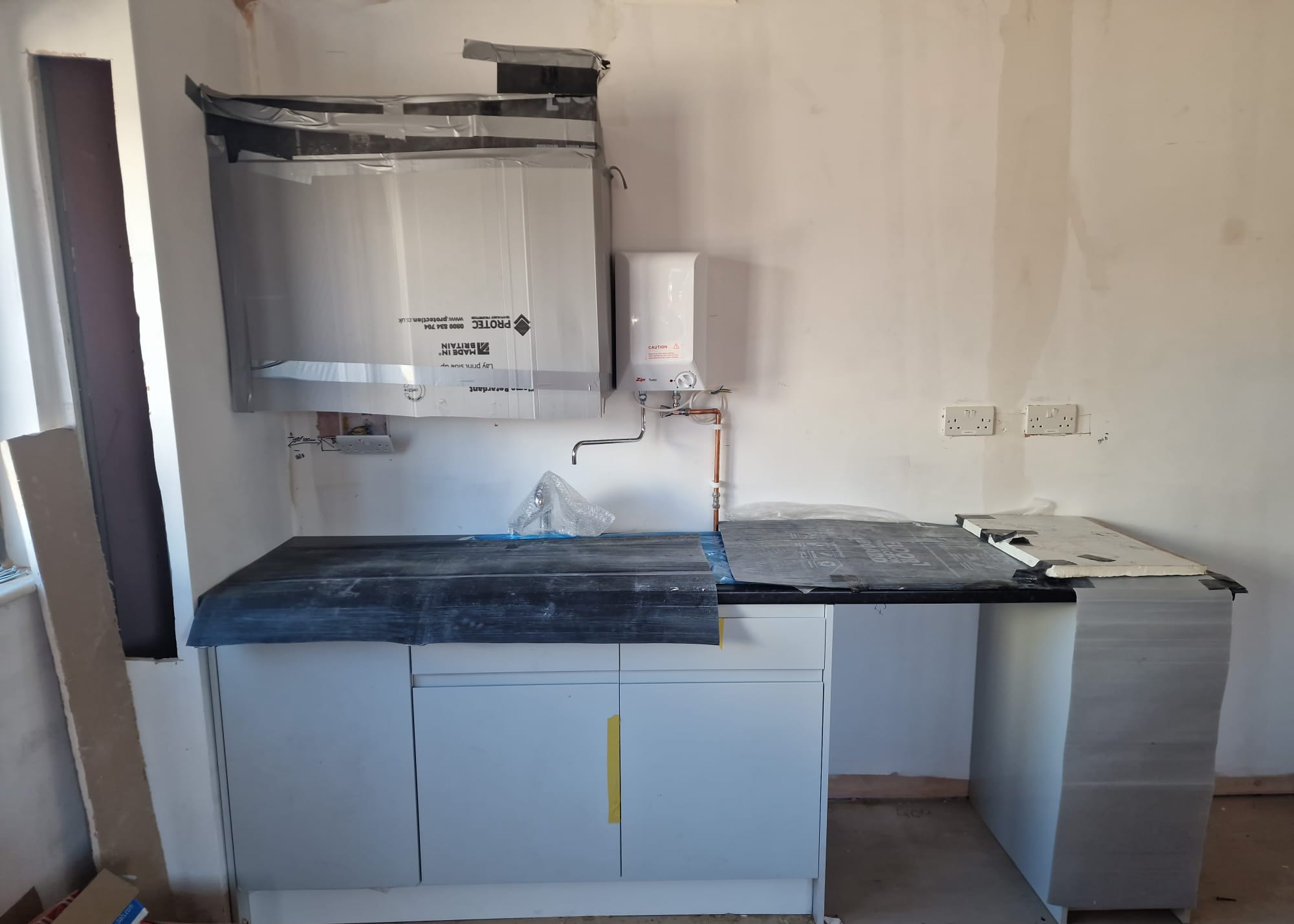 Welfare kitchen during installation with protective coverings in place