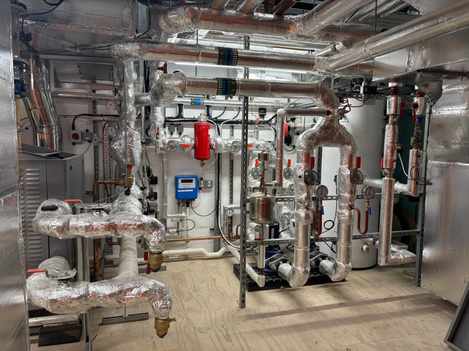 Insulated plant room pipework, valves and pumps at Crystal Palace Football Academy