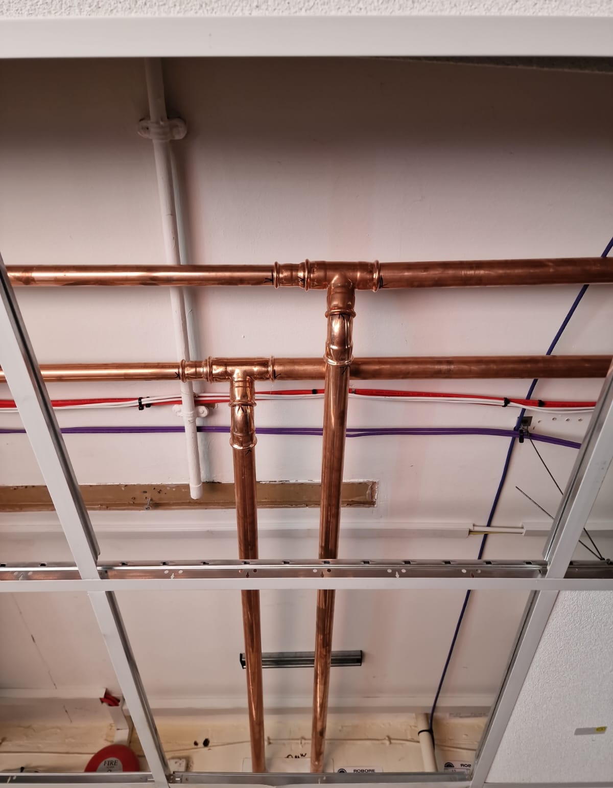 Copper branch connections within the ceiling void