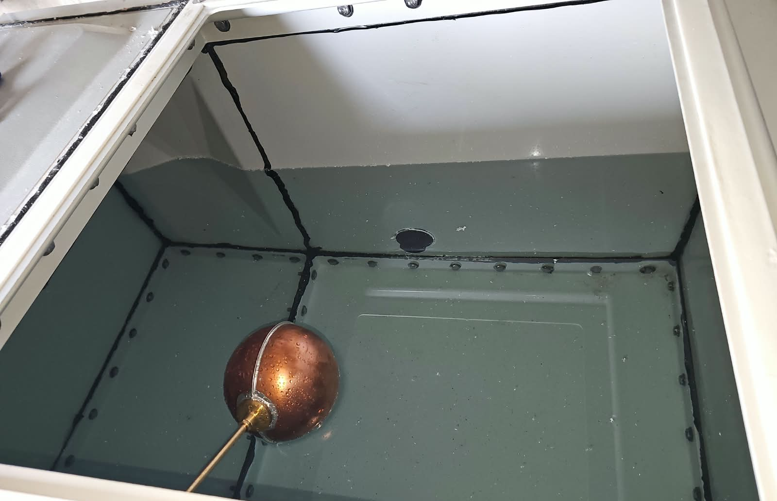Internal view of the sectional tank and float valve during assembly