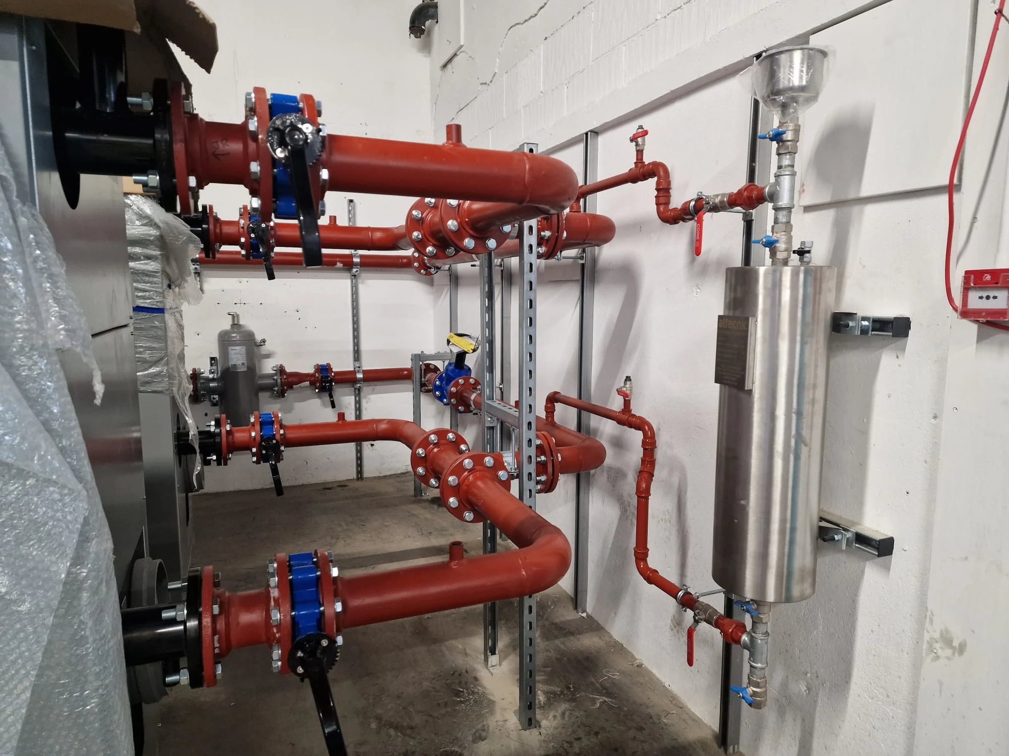 Flanged LTHW primary pipework and valves at the boilers during installation