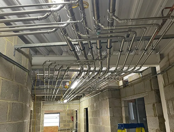 Stainless steel press pipework with branches and fittings at ceiling level