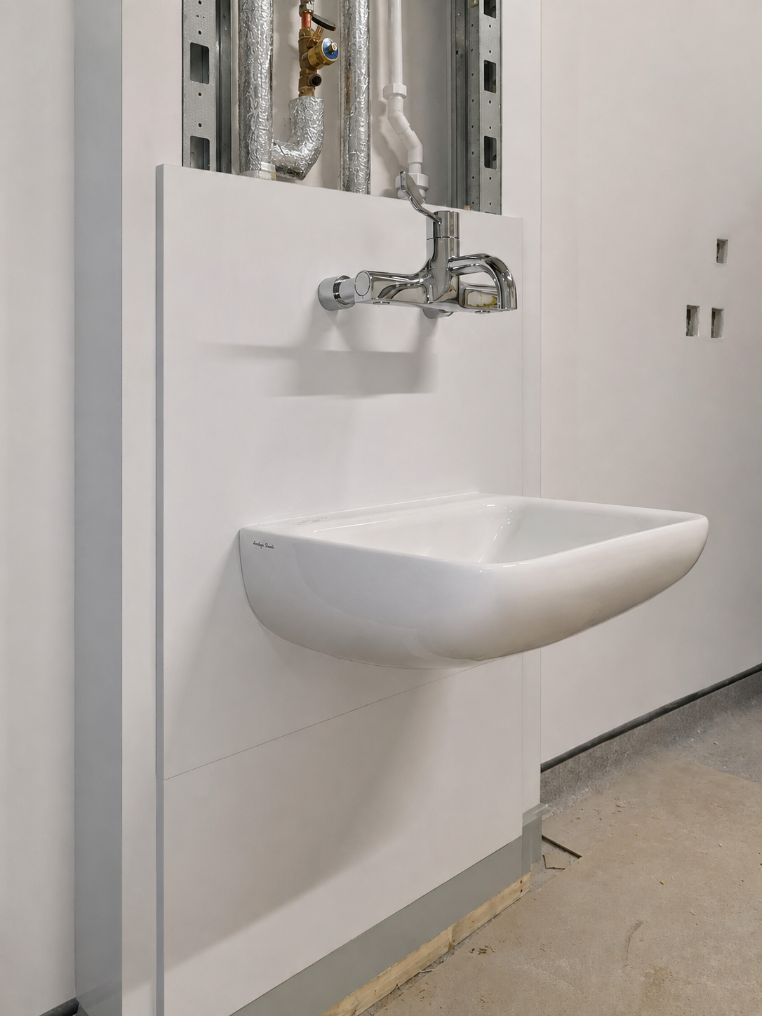 Clinical wash hand basin with exposed service void during installation